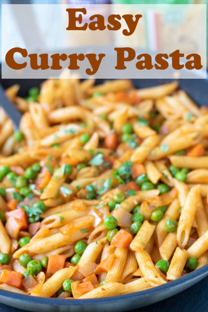 A shallow pan of easy curry pasta cooked and ready to serve. Pin title text overlay at top.