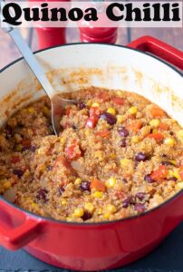 A casserole pot of quinoa chilli with a spoon in. Pin title text overlay at top.