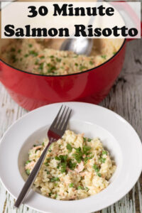 A plate of 30 minute salmon risotto with peas with a fork over the top. Rest of salmon risotto in a casserole pot above. Pin title text overlay at top.