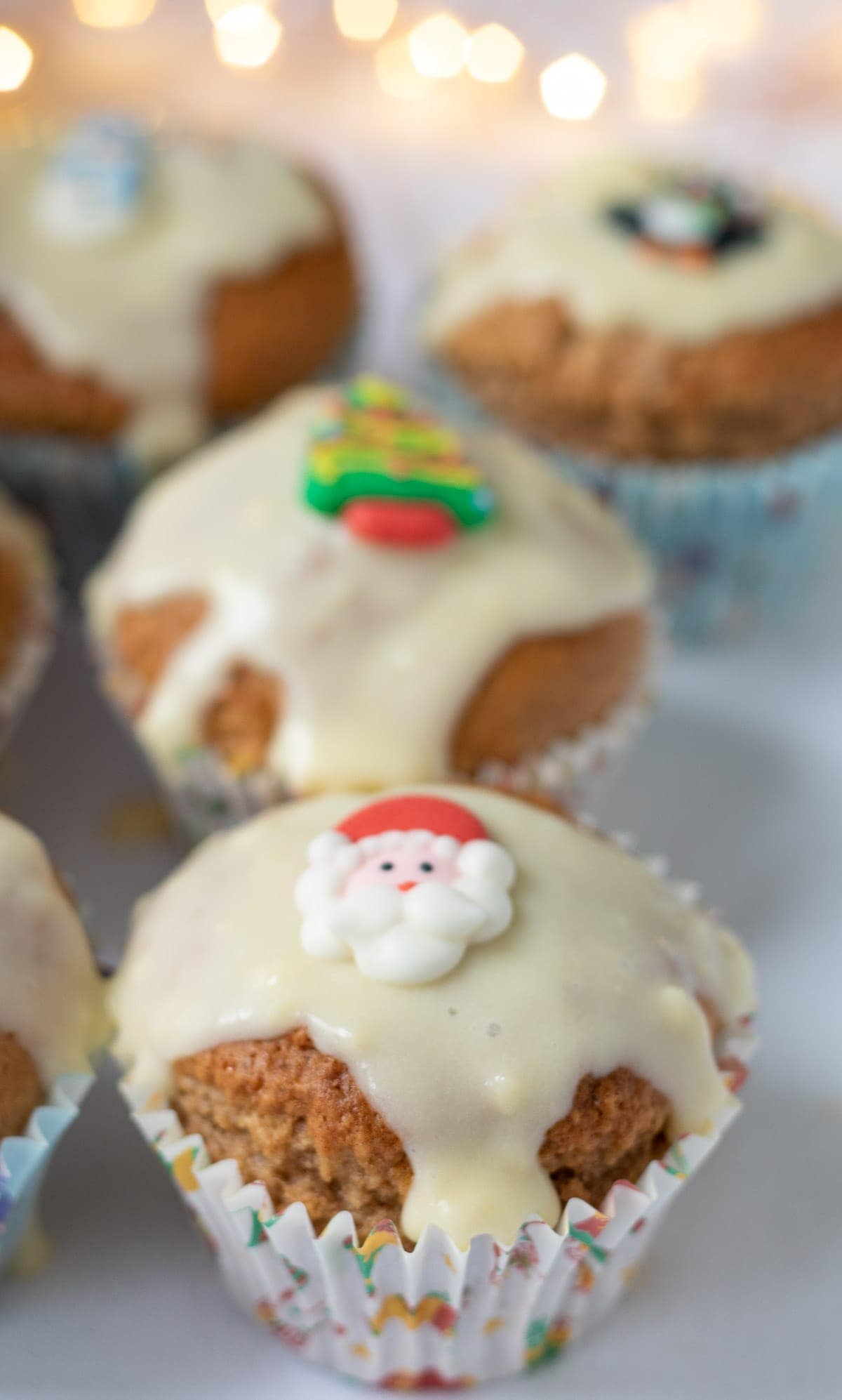 Close up of four gingerbread muffins with cream cheese icing.