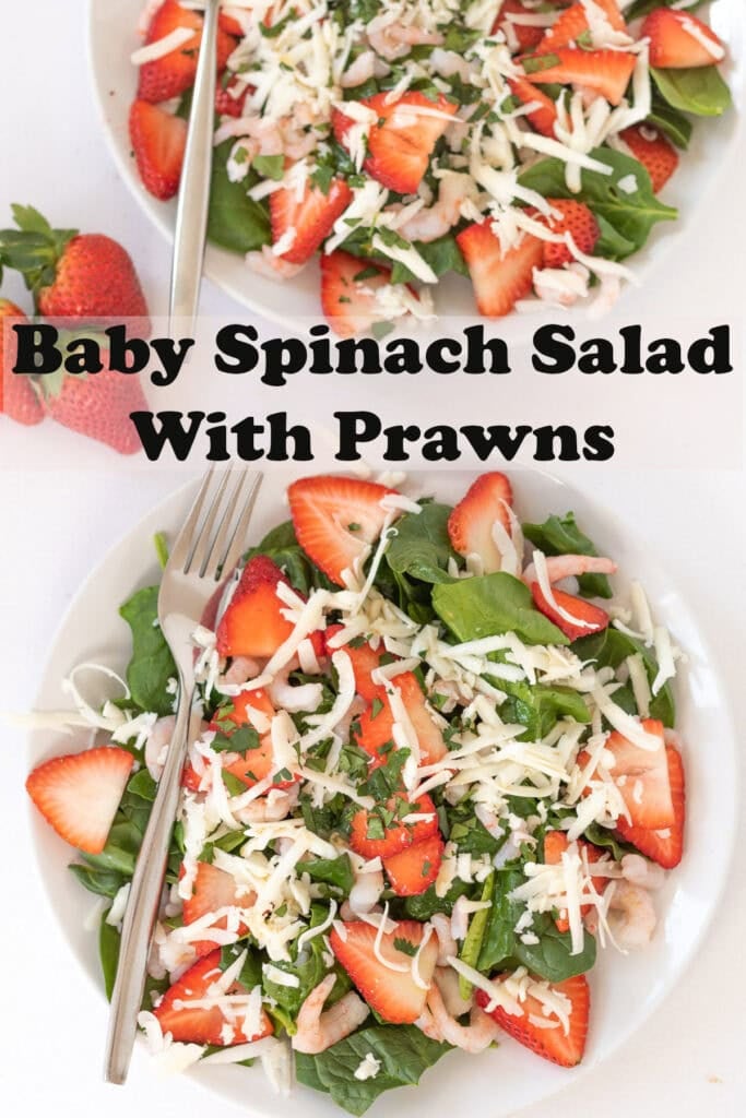 Overhead view of two plates of baby spinach salad with prawns. Pin title text overlay through middle.