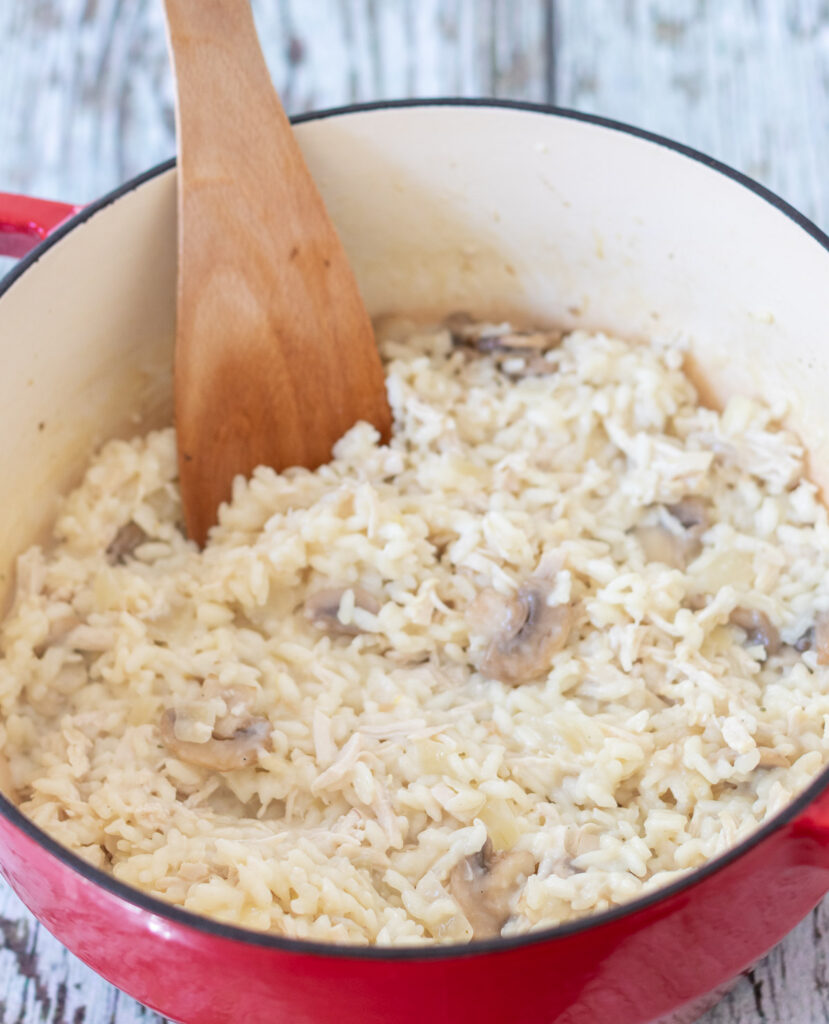 Mushrooms and garlic stirred into casserole pot of cooked rice.