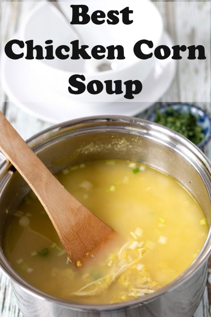 Best chicken corn soup in a large saucepan with a wooden stirring spoon in. Pin title text overlay at top.