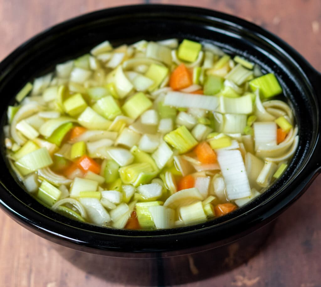 All vegetable ingredients and stock in slow cooker.