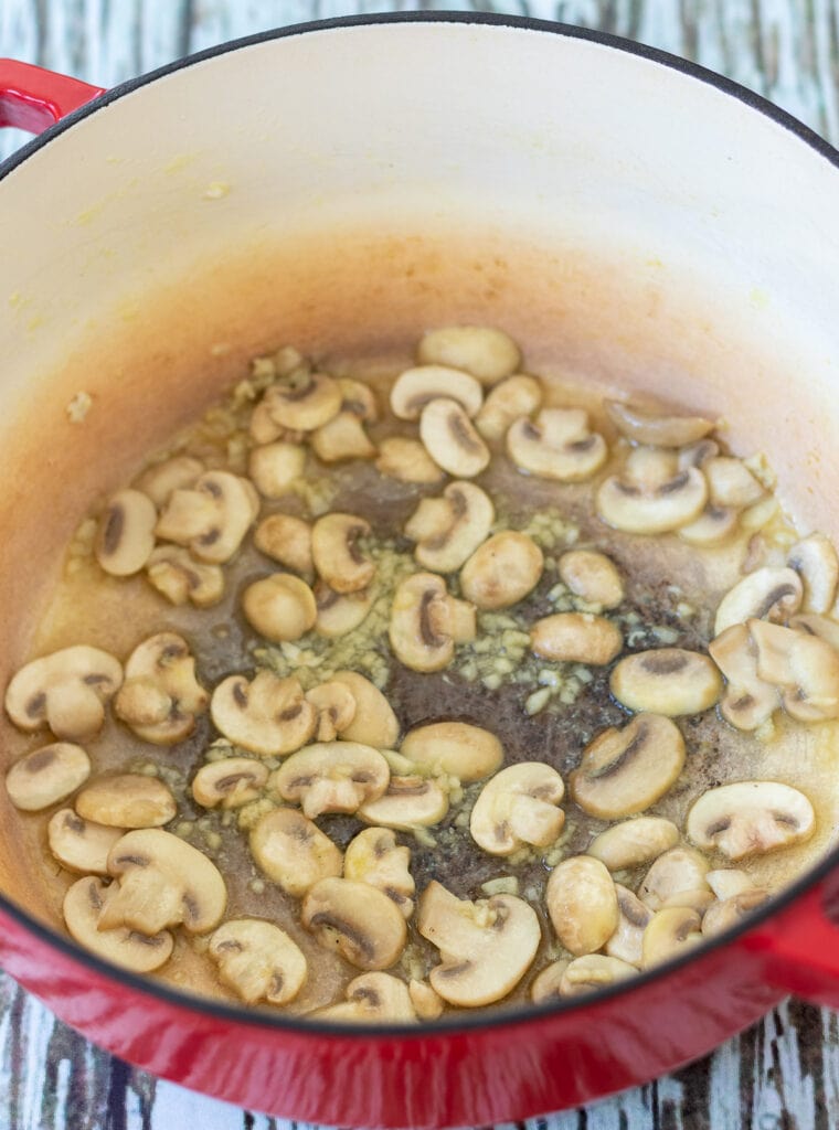 Mushroom and garlic sauteed together in a large casserole pot.