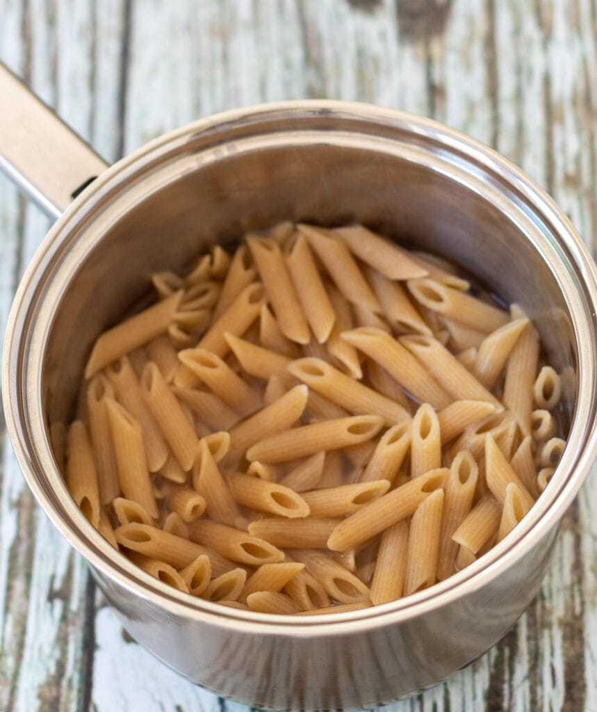 Cooked wholewheat pasta in a saucepan.