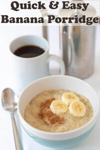 A bowl of quick and easy banana porridge topped with sliced banana and cinnamon with a spoon to the side. Mug of coffee and caffetiere in the background. Pin title text overlay at top.