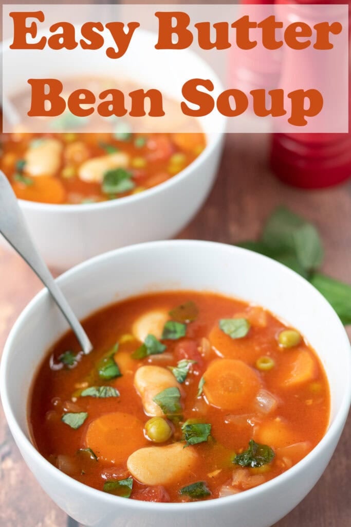 A bowl of easy butter bean soup with a soup spoon in. Pin title text overlay at top.