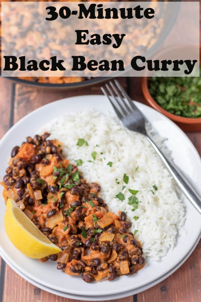 30-minute easy black bean curry served on a plate with basmati rice and garnished with chopped coriander and a lemon to the side. Pin title text overlay at top.