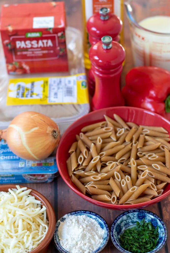 Easy creamy chicken pasta bake ingredients laid out on a table.