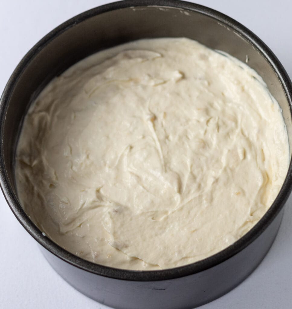 Cream cheese mixture spooned and smoothed over the biscuit base.