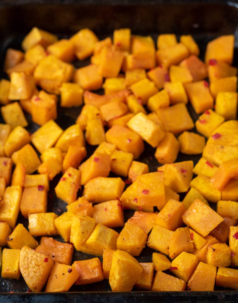 Oven roasted cubes of spicy butternut squash removed from oven.