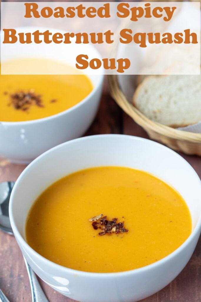 A bowl of butternut squash soup, garnished with some dried chilli flakes. Pin title text overlay at top.