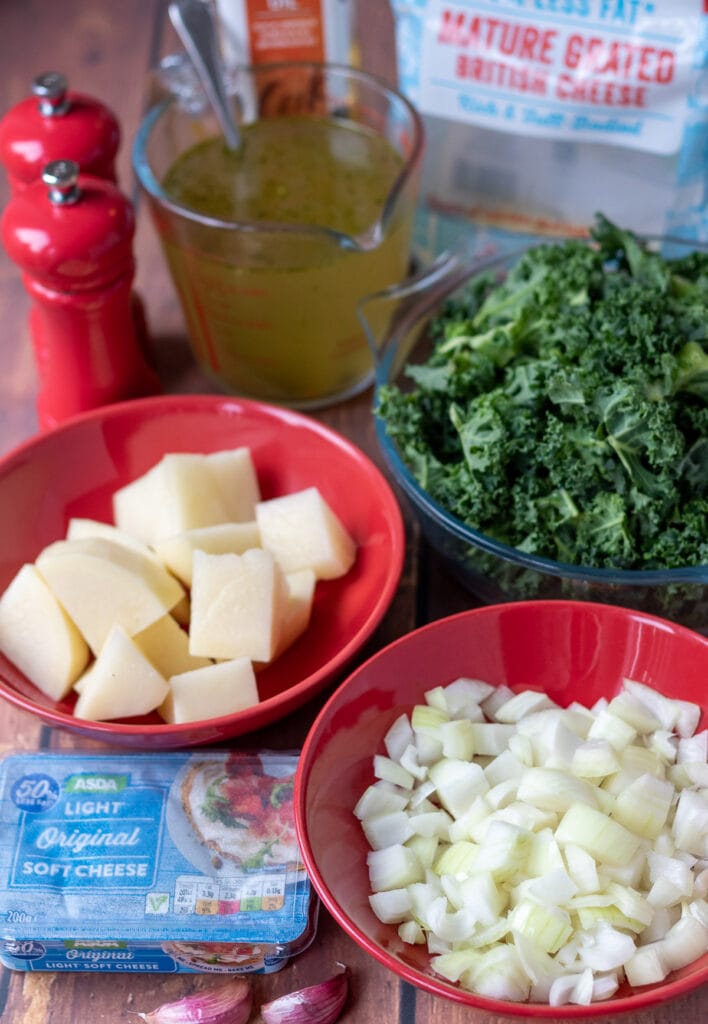 Healthy creamy kale soup ingredients laid out on a table.