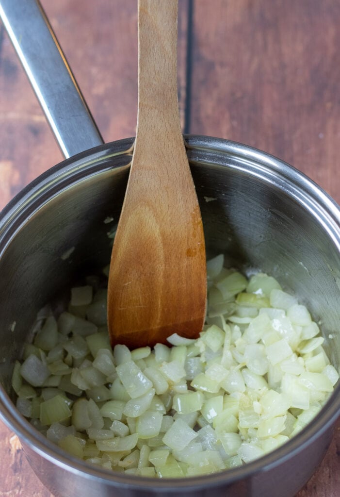 Onion and garlic being sautéd in the saucepan.