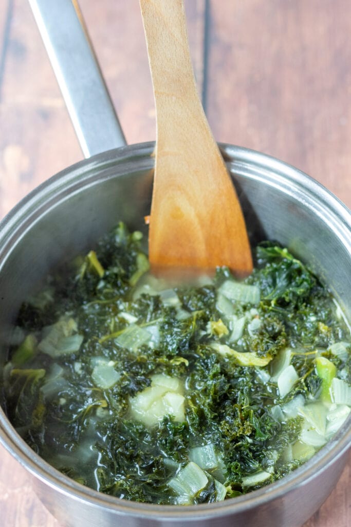 Curly Kale, potatoes and vegetable stock added to pot and simmered.