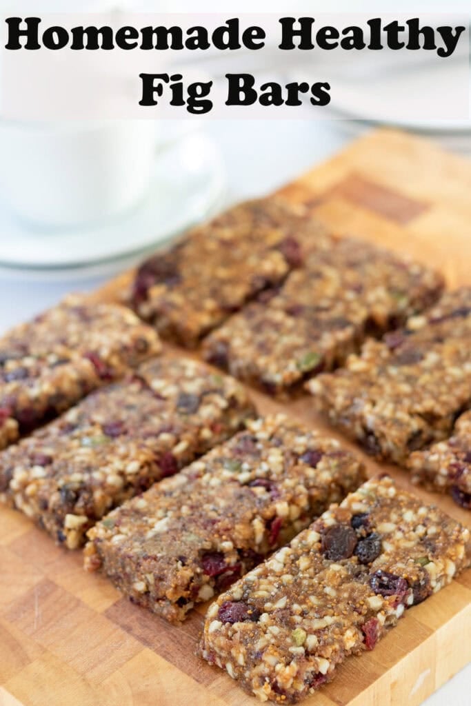 Homemade healthy fig bars laid out diagonally across a chopping board. Pin title text overlay at top.
