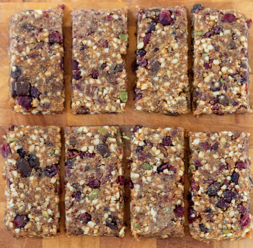 Birds eye view the fig bar mixture cut into 8 fig bars on a chopping board. 