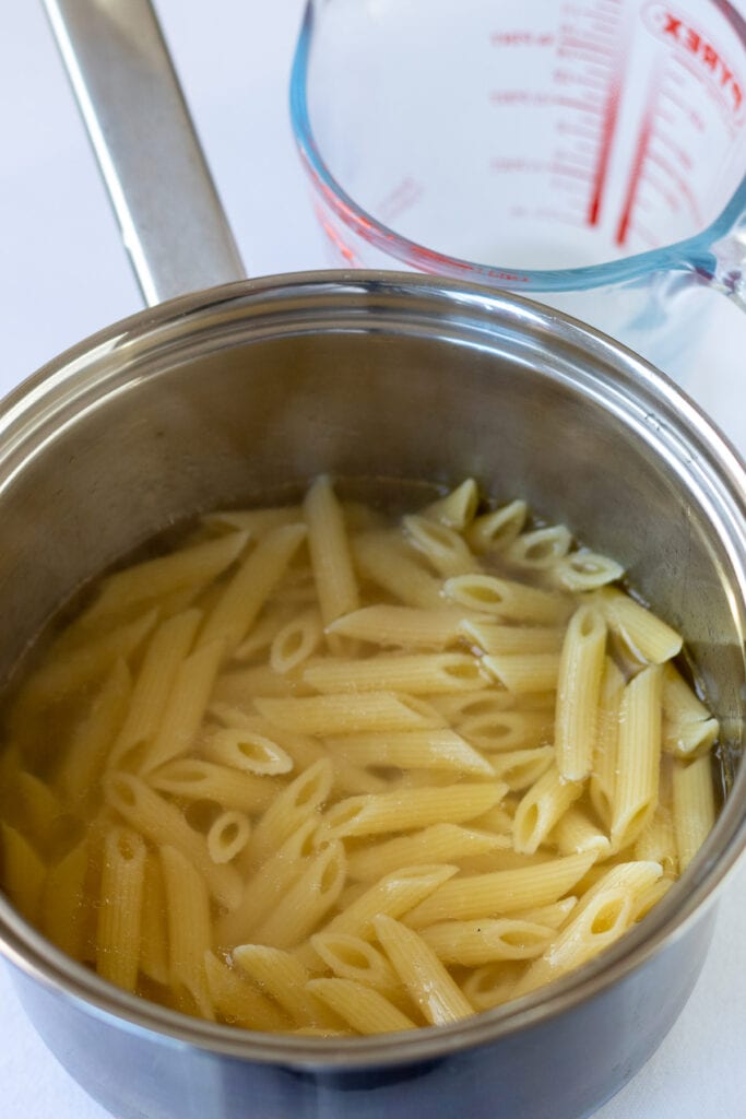 Penne pasta in a saucepan.