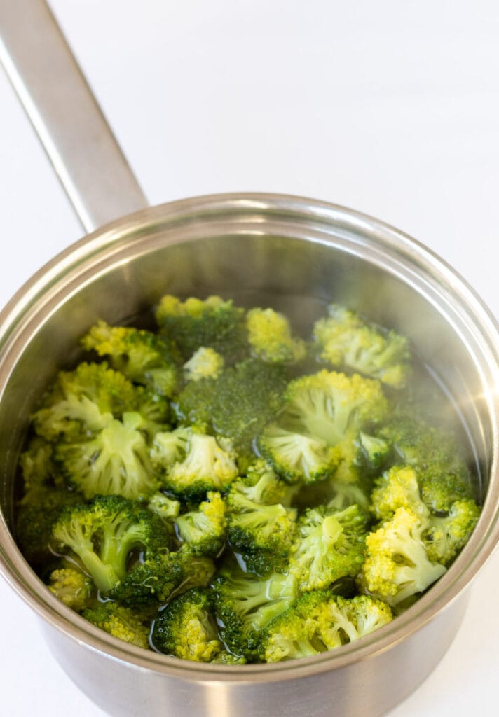 Broccoli pieces cooked in a medium sized saucepan.