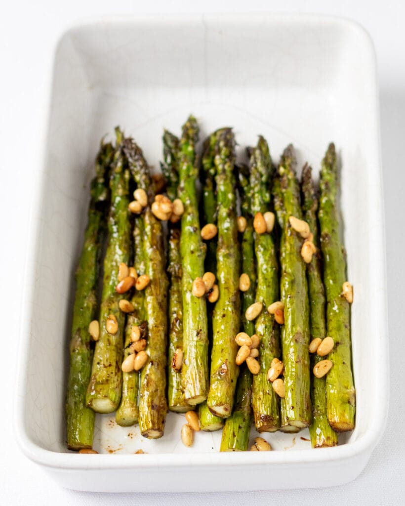 Roasted balsamic asparagus served in a rectangle white serving dish.