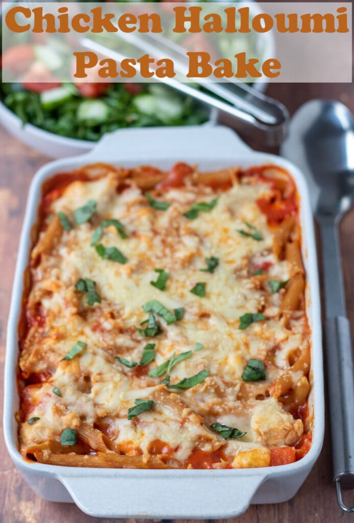 Chicken and halloumi pasta bake cooked in a pasta dish. Pin title text overlay at top.