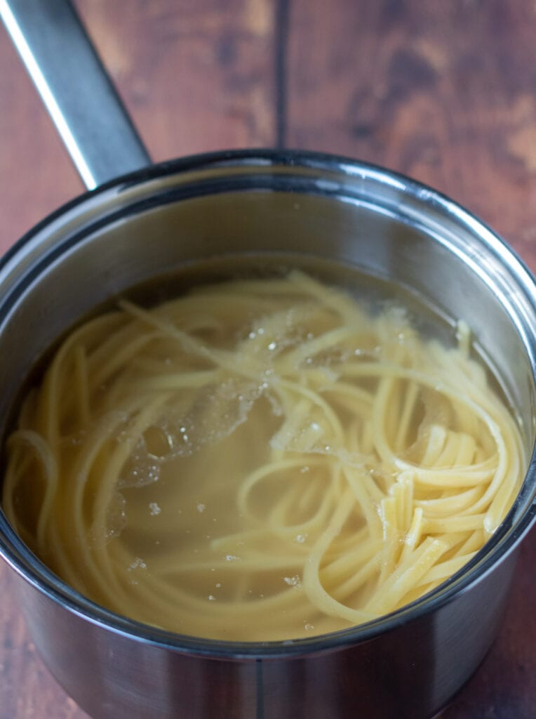Linguine cooked in a pan of salted boiling water.
