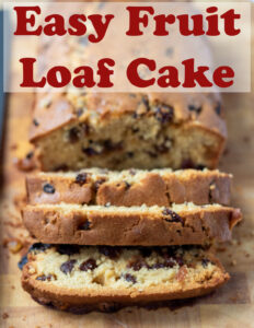 Easy fruit loaf cake on a chopping board facing forward with three slices cut off the front. Pin title text overlay at top.
