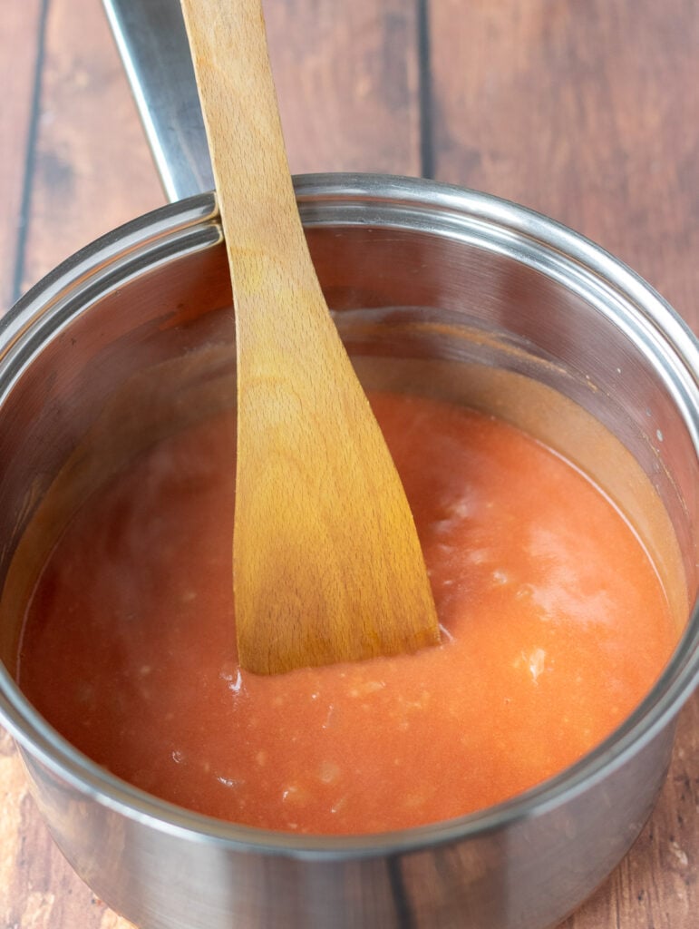 Tomato passata stirred into the white sauce.