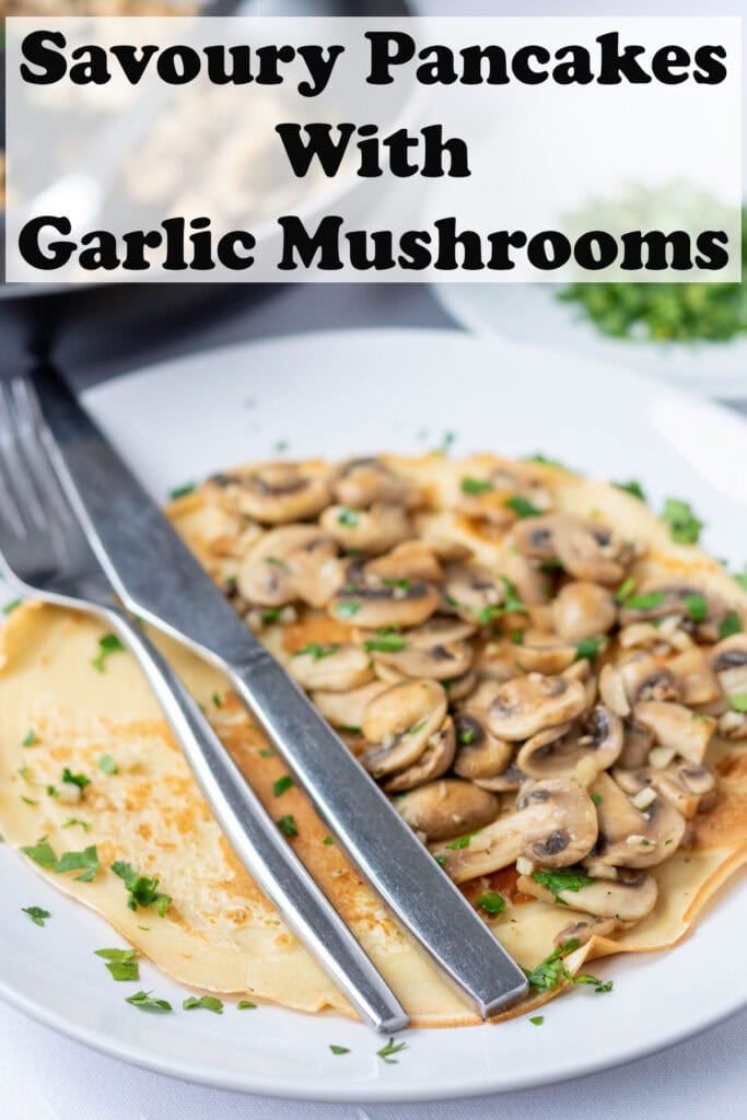 A plate of savoury pancakes topped with garlic mushrooms. Knife and fork to the side. Pin title text overlay on at top.