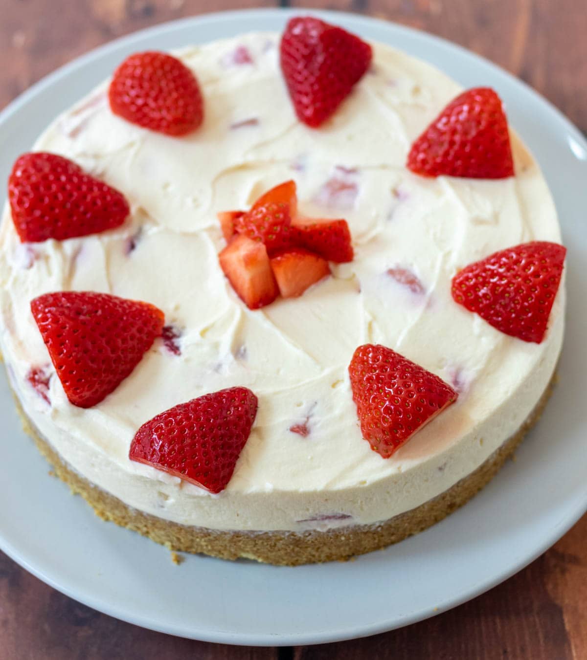 Easy no-bake strawberry cheesecake decorated and served on a plate.
