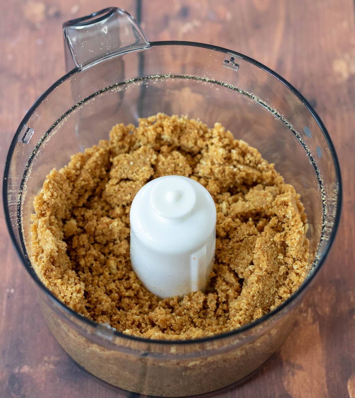Biscuit crumbs and butter blitzed and combined together in a food processor.