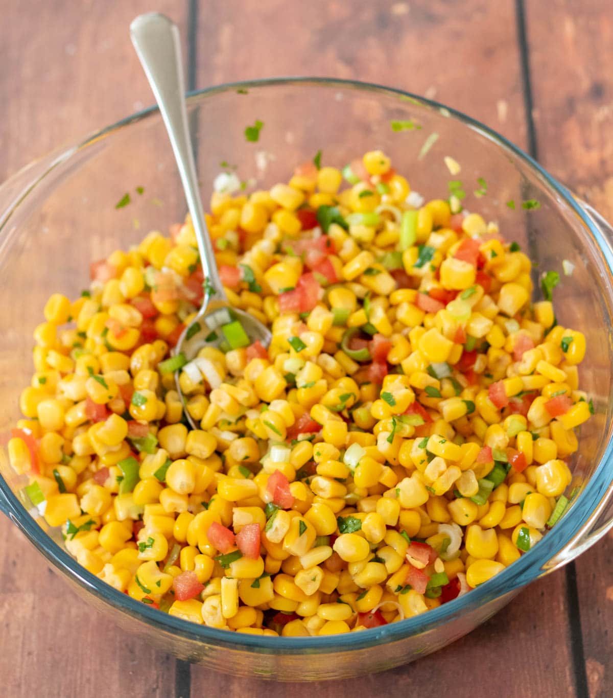 All the corn salsa ingredients placed into a large mixing bowl.