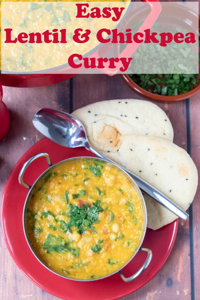 Overhead view of a balti dish of easy lentil and chickpea curry garnished with chopped coriander with naan breads and a spoon to the side. Text name of recipe overlay at top.