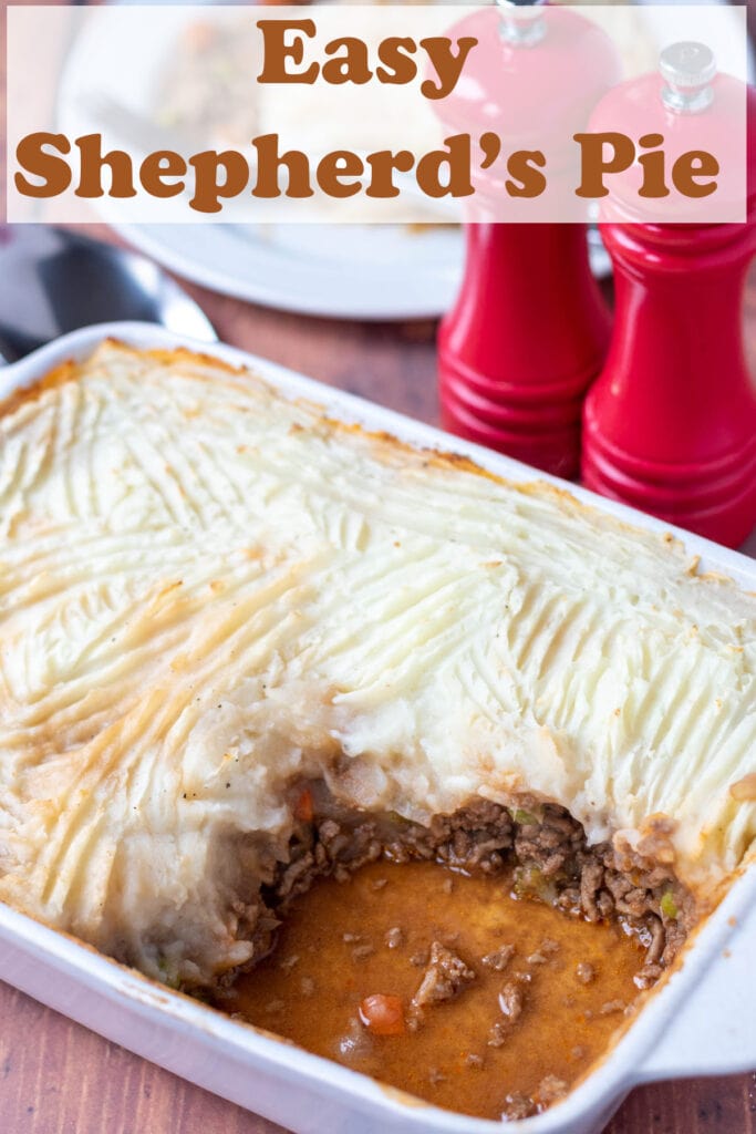Easy shepherd's pie made with frozen vegetables in a casserole dish with a portion removed. Salt and pepper cellars and a plate with the portion on in the background.