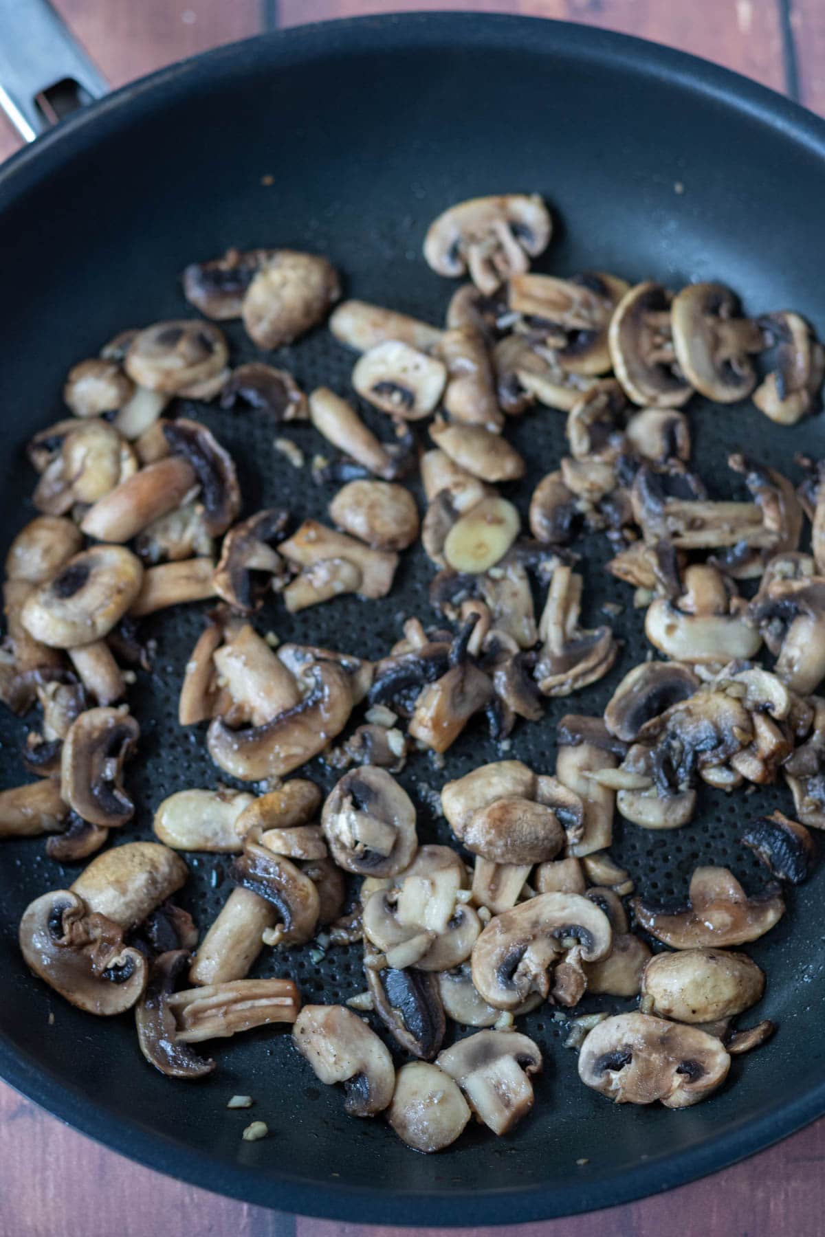 Sauté mushrooms and garlic in a large frying pan.