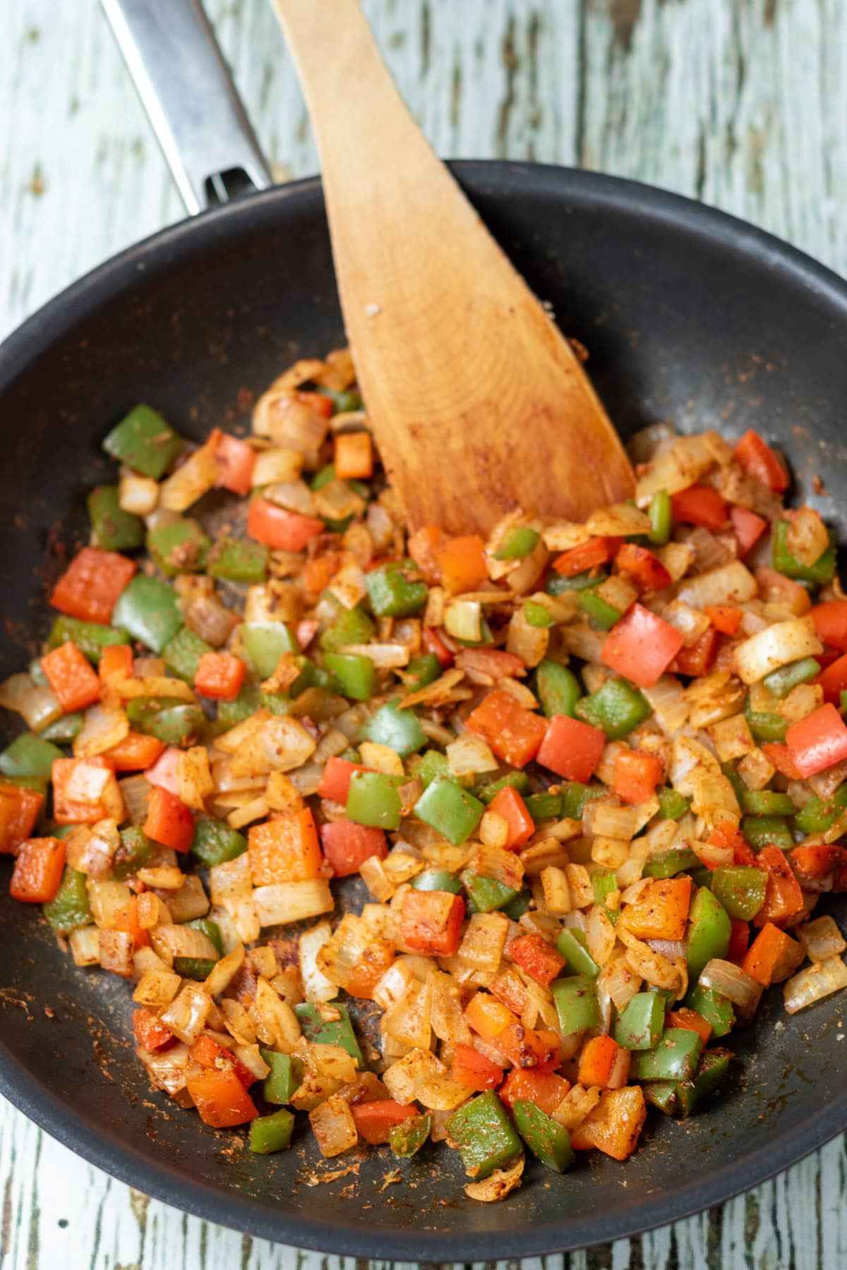 Cumin, paprika and chilli powder stirred into the sauted onion, garlic, red and green peppers.