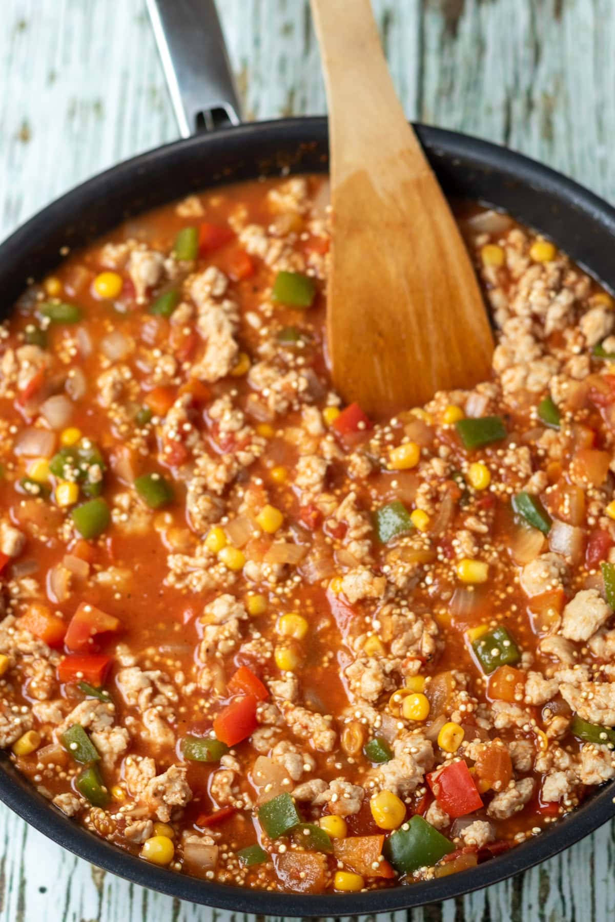 Sweetcorn, chopped tomatoes, rinsed quinoa, chicken stock, salt and pepper, the cooked chicken mince added to the vegetables in the pan.