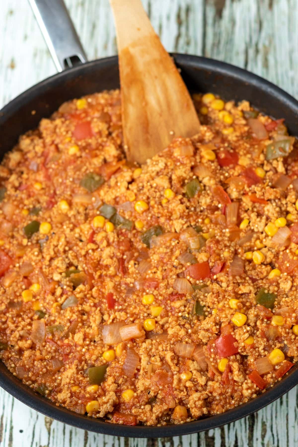 One pan chicken and quinoa ingredients simmering in the pan.