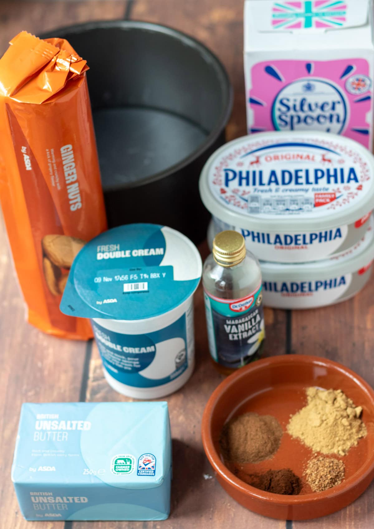No bake gingerbread cheesecake ingredients laid out on a table.