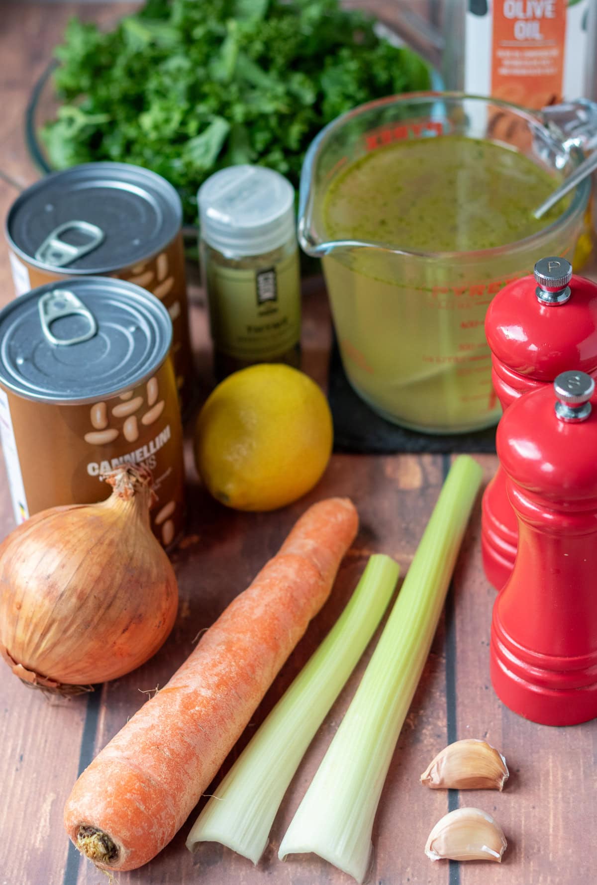 White bean and kale soup ingredients laid out on a table.