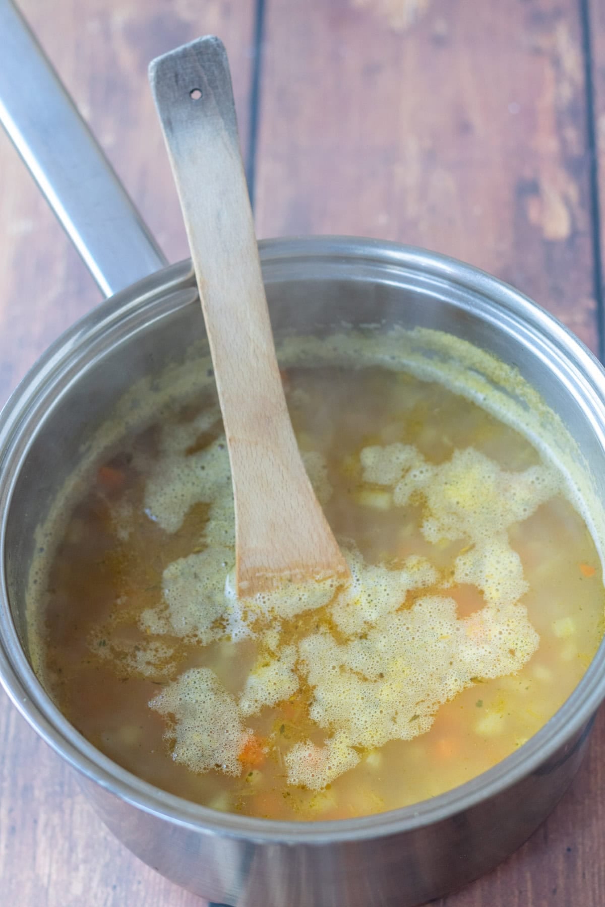 Dried thyme, cannellini beans and vegetable stock added to the pan of vegetables.