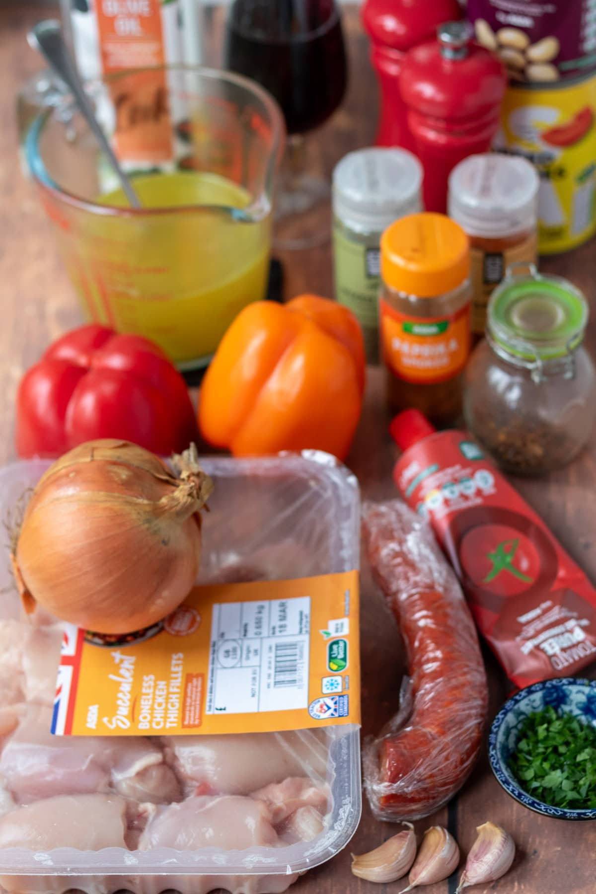 One pot Spanish chicken and chorizo stew ingredients laid out on a table.