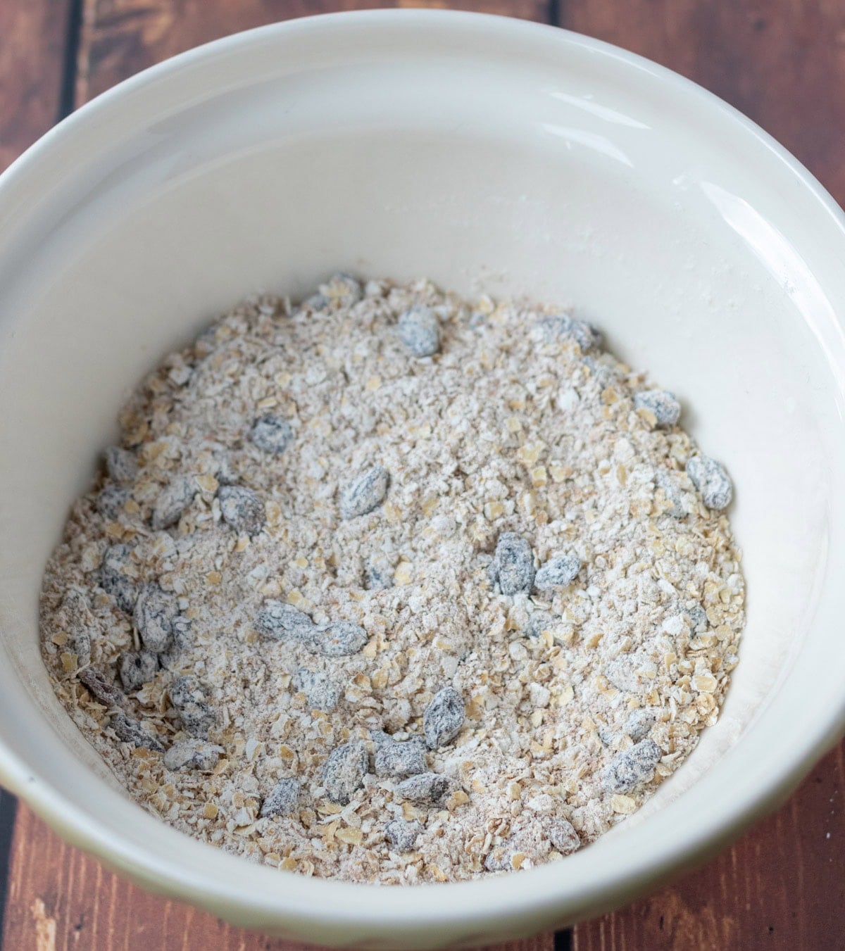 Raisins stirred into the large bowl with the oats, flour, baking powder and cinnamon.
