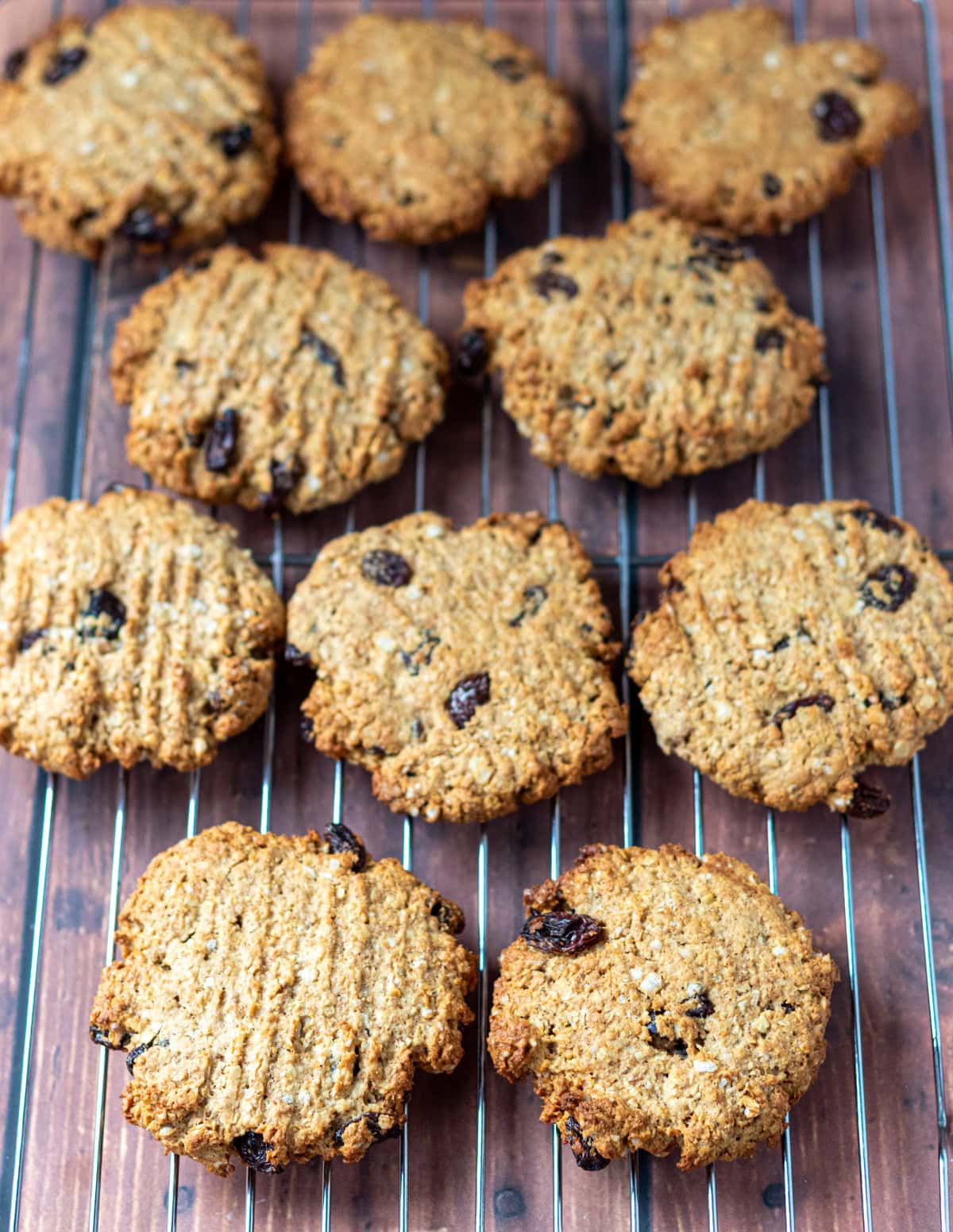 Batch of raisin oat cookies cooling on a wire rack.
