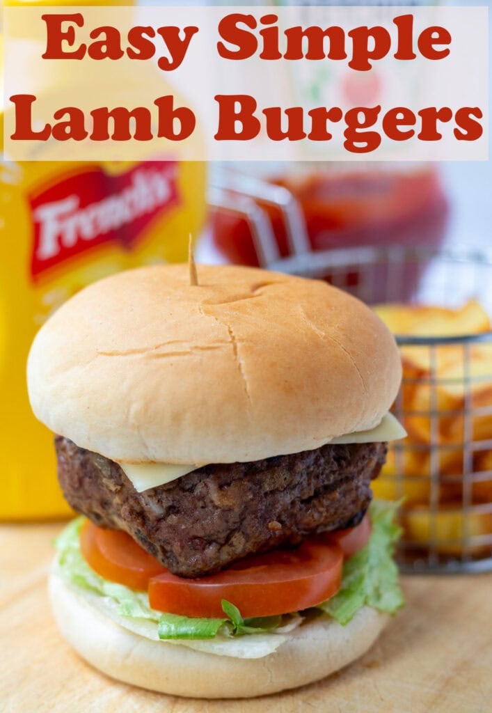 Easy simple lamb burger in a burger bun on a bed of lettuce and sliced tomato. Pin title text overlay at top.
