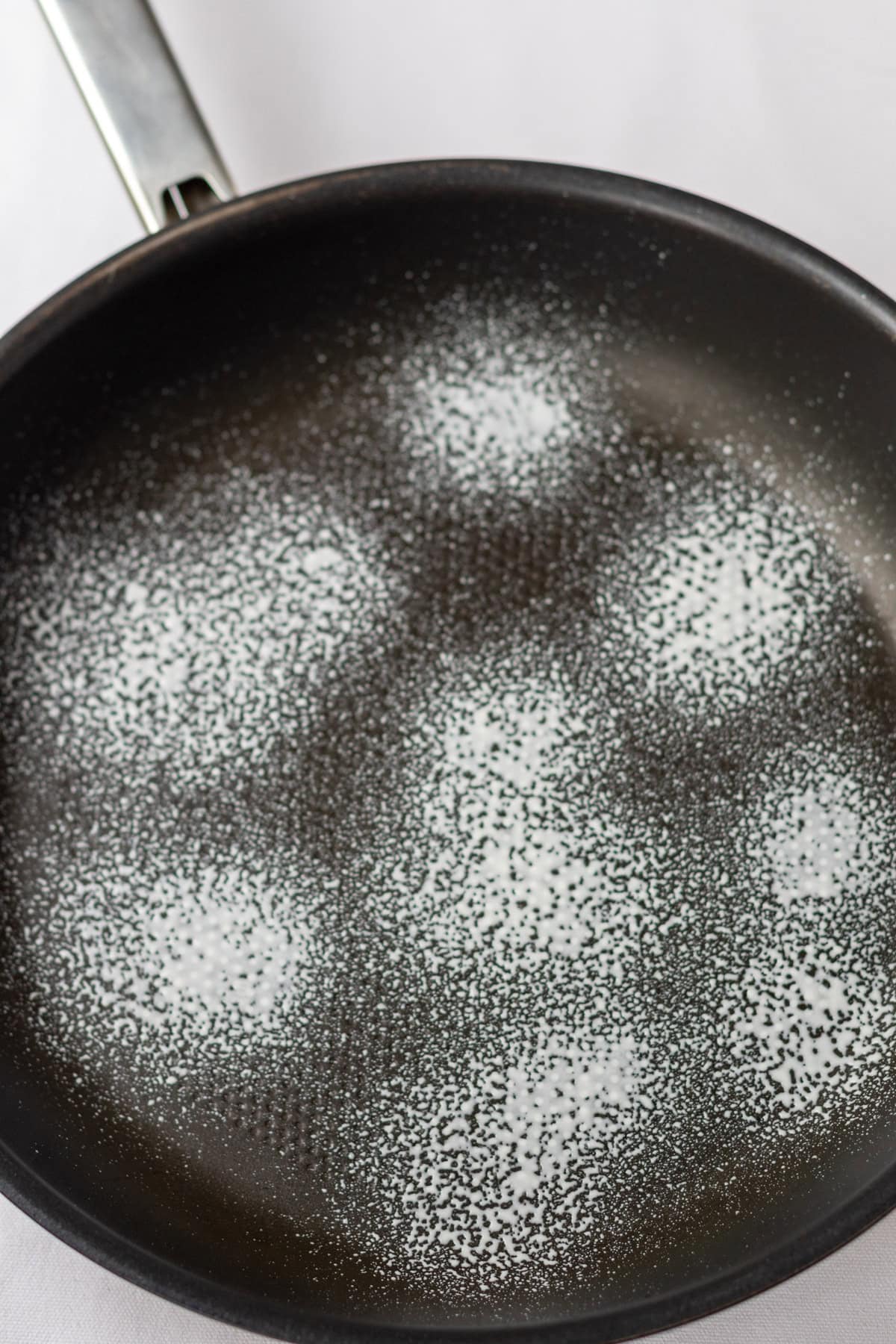 A non-stick fying pan sprayed with low calorie cooking spray.