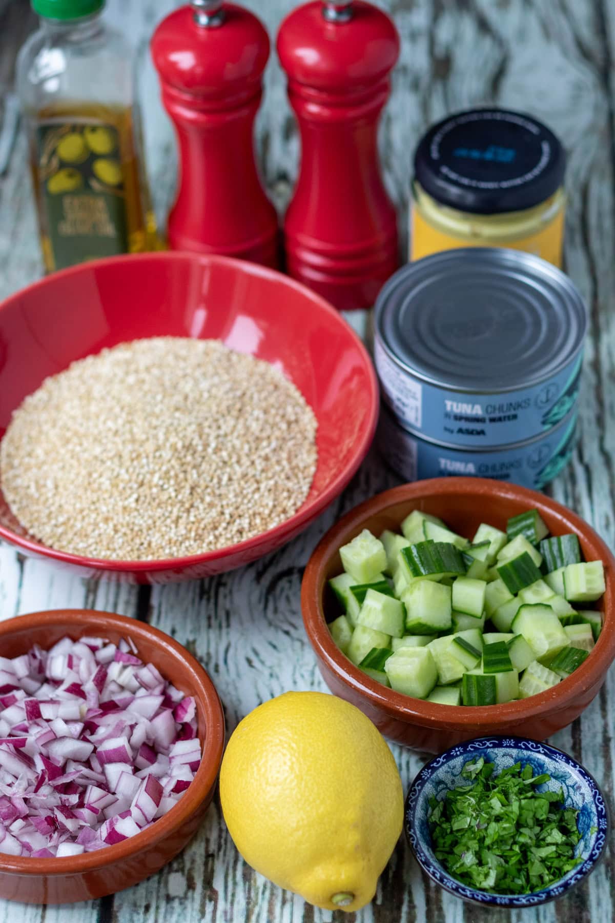 Quick tuna quinoa salad ingredients laid out on a table.