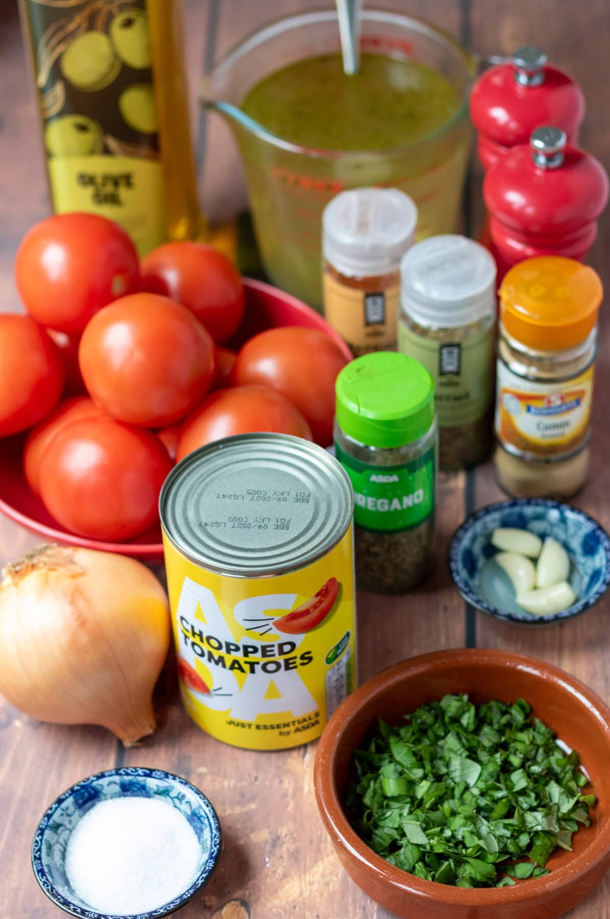 Simple roasted tomato basil soup ingredients all laid out on a table.