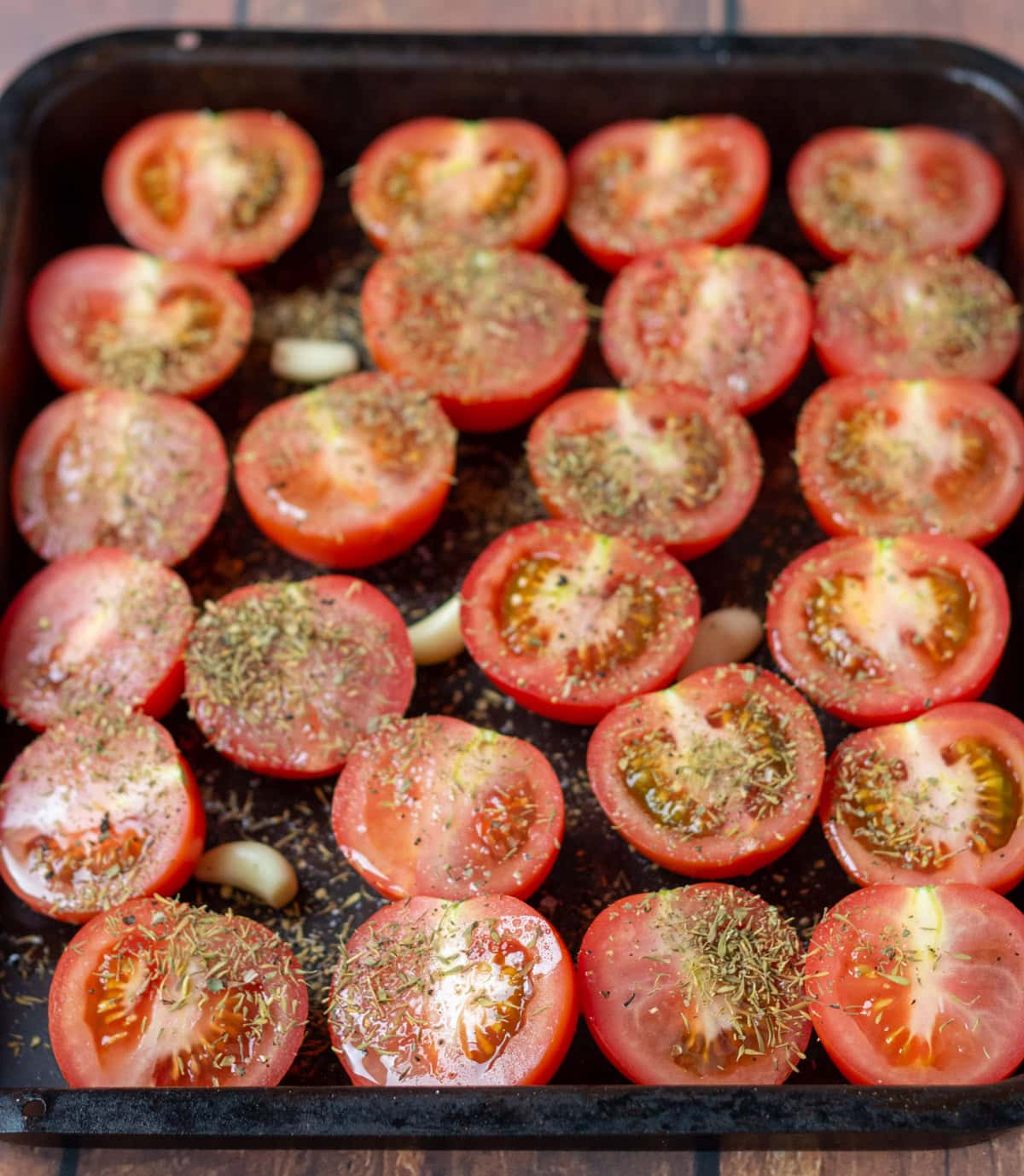 Halved tomatoes on a baking tray, cut side up drizzled with olive oil, salt and pepper , dried thyme and dried oregano.